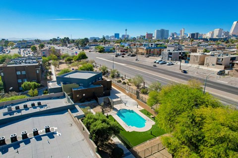 an aerial view of a parking lot with a pool and a city in the background at Maryland Villas Apartments, Nevada